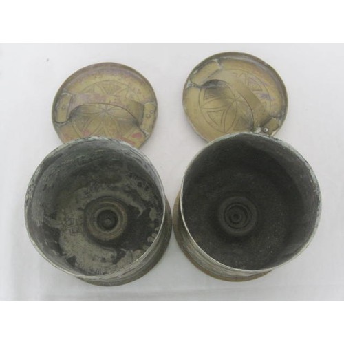 144 - A pair of 1918-dated Trench Art shell cases formed as lidded pots, one decorated with a hunting dog ... 