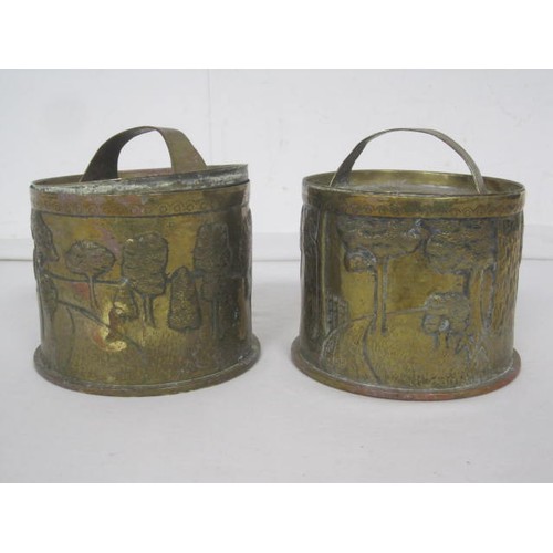 144 - A pair of 1918-dated Trench Art shell cases formed as lidded pots, one decorated with a hunting dog ... 