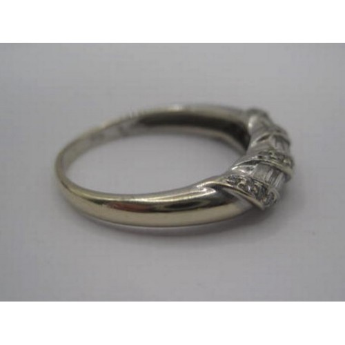 173 - A distinctive 18 carat imported white gold dome baguette diamond ring. Ring size N/O, gross weight o... 