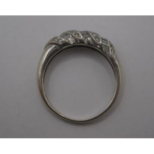 173 - A distinctive 18 carat imported white gold dome baguette diamond ring. Ring size N/O, gross weight o... 