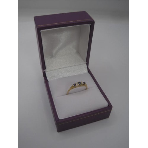 174 - An 18 carat gold sapphire and diamond ring. Ring size K/L, gross weight approx. 1.8g. Set with three... 