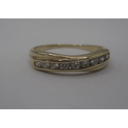 175 - A 9 carat gold ring set with a row of nine faux white stones, ring size P, gross weight approx. 1.9g... 