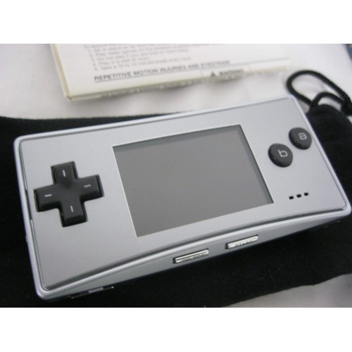 164 - A Game Boy Micro with carry pouch and instructions but no box, plus 4 Game Boy Advance Games: Mario ... 