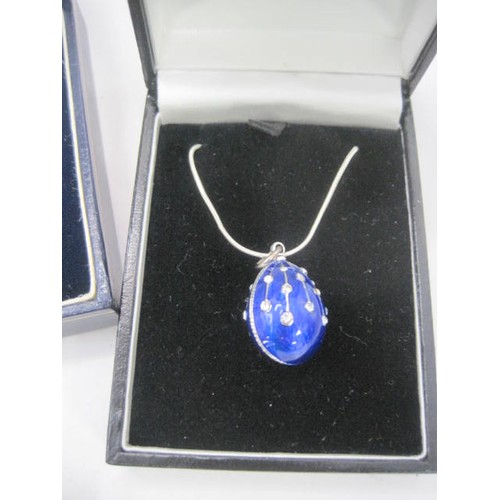 46 - Three 925 silver pendant necklaces each in presentation boxes, and a white metal brooch. (1) A blue ... 