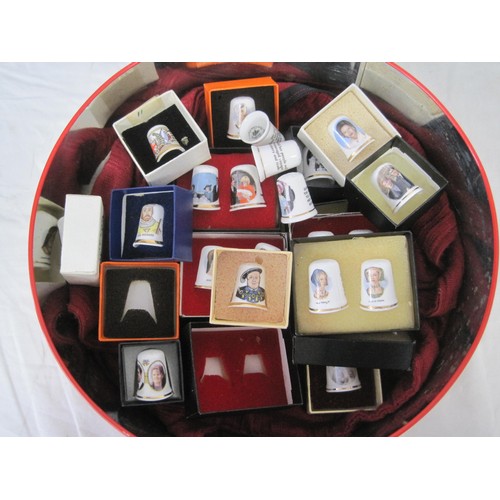 134 - Two round tins of collectors' thimbles and display cases