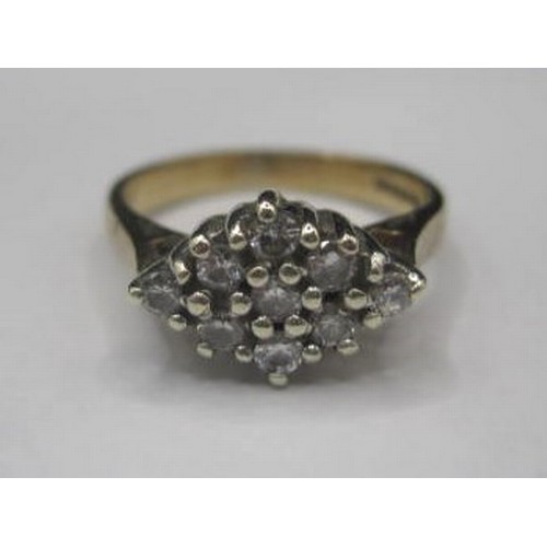 183 - A 9ct gold ring with nine chip Diamonds in a Diamond shaped setting. Total setting size 10mm by 7mm ... 