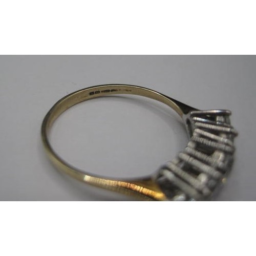 184 - A 9ct gold ring size in a good size with 5 CZ stones in a brillant cut . Raised setting size  20mm l... 