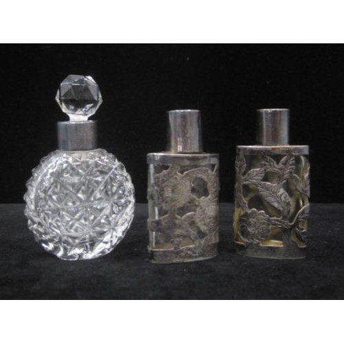 234 - Four silvered collared Perfume bottles two marked Sterling and two with full hallmarks to the silver... 