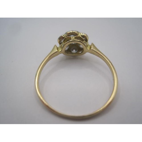 256 - A pretty and eye-catching gold seven-stone diamond ring in a foliate setting. Ring size N, gross wei... 