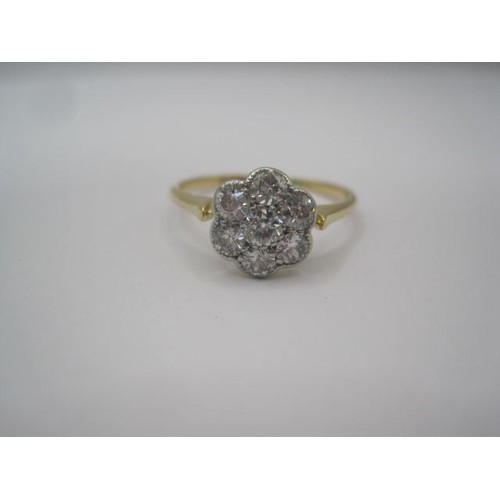 256 - A pretty and eye-catching gold seven-stone diamond ring in a foliate setting. Ring size N, gross wei... 