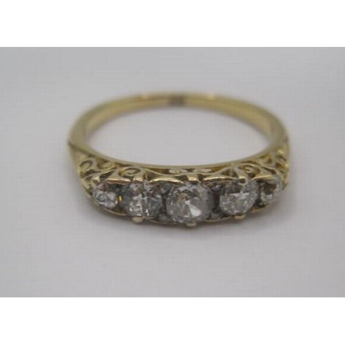 249 - An impressive 18 carat gold five-stone diamond ring. A row of five graduated round cut diamonds, the... 