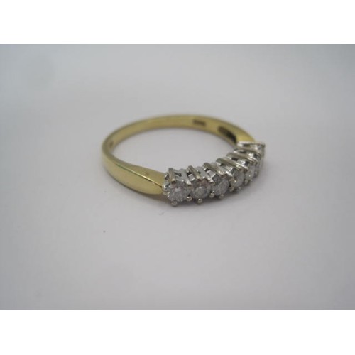 253 - An 18 carat gold seven stone diamond ring. A row of seven diamonds in claw setting. Ring size R, gro... 