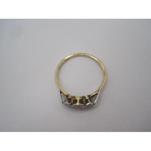 257 - An 18 carat gold ring with a row of three small diamonds in illusion setting, ring size Q, gross wei... 