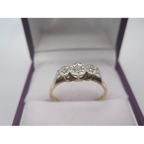 257 - An 18 carat gold ring with a row of three small diamonds in illusion setting, ring size Q, gross wei... 