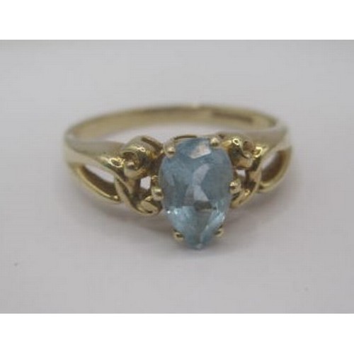 252 - A 9 carat gold ring set with a pear cut aquamarine in a pierced and scrolled shoulder setting. Ring ... 