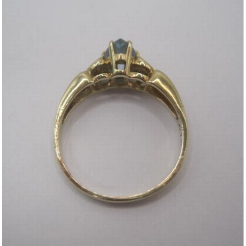 252 - A 9 carat gold ring set with a pear cut aquamarine in a pierced and scrolled shoulder setting. Ring ... 