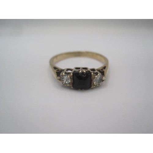 254 - A 9 carat gold ring set with a square-cut sapphire centrally, with a white stone to either side, rin... 