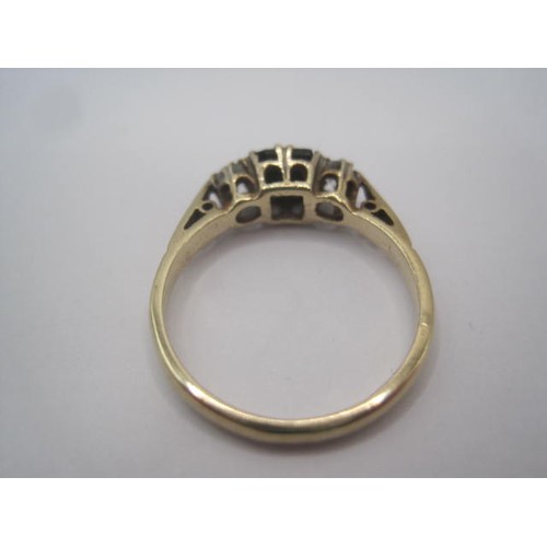 254 - A 9 carat gold ring set with a square-cut sapphire centrally, with a white stone to either side, rin... 