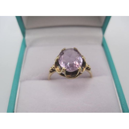 259 - A 9 carat gold amethyst ring, the oval amethyst estimated at 10.5mm x 8.5mm, in a looped claw settin... 