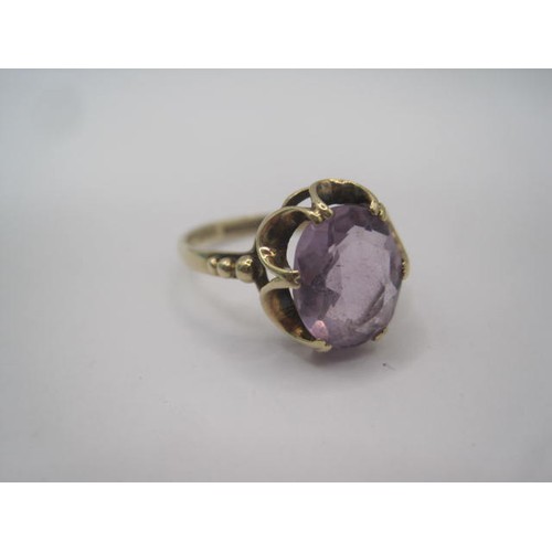 259 - A 9 carat gold amethyst ring, the oval amethyst estimated at 10.5mm x 8.5mm, in a looped claw settin... 