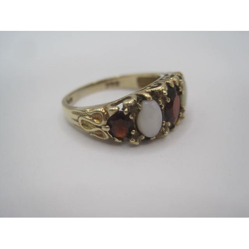 247 - A 9 carat gold opal and garnet ring, a row of three graduated garnets separated by two opals in a ra... 