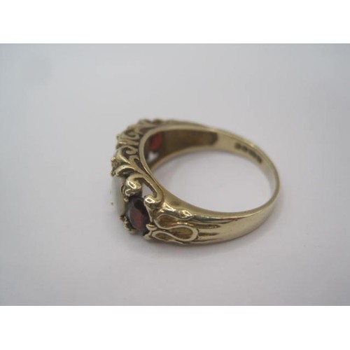 247 - A 9 carat gold opal and garnet ring, a row of three graduated garnets separated by two opals in a ra... 