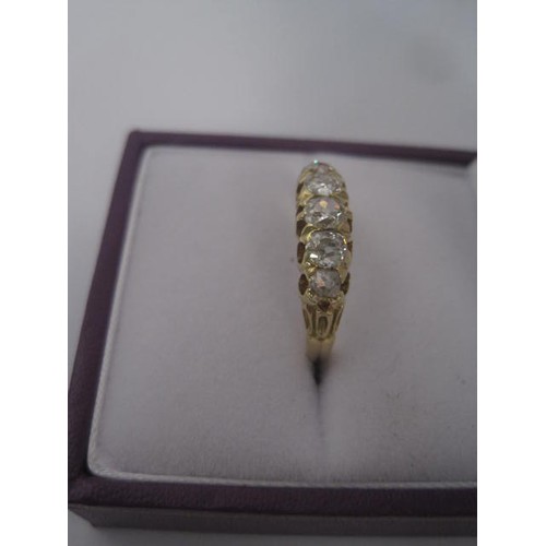 264 - An impressive gold ring set with a row of five graduated diamonds, ring size L, gross weight of ring... 