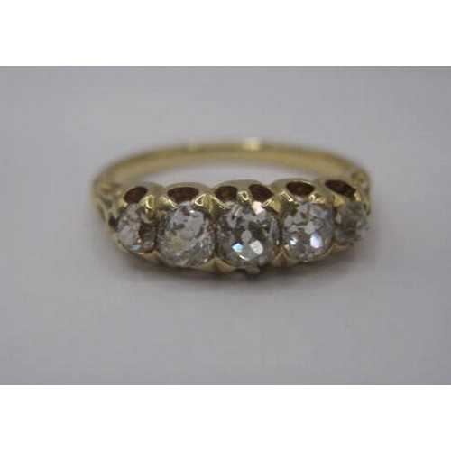 264 - An impressive gold ring set with a row of five graduated diamonds, ring size L, gross weight of ring... 