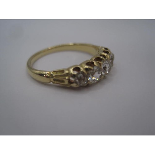 264 - An impressive gold ring set with a row of five graduated diamonds, ring size L, gross weight of ring... 