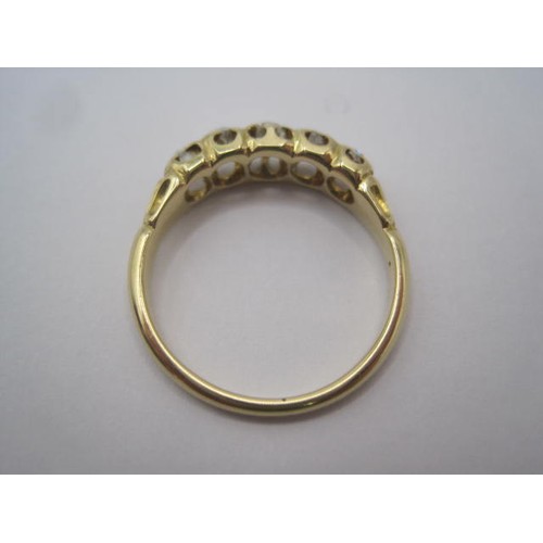 264 - An impressive gold ring set with a row of five graduated diamonds, ring size L, gross weight of ring... 