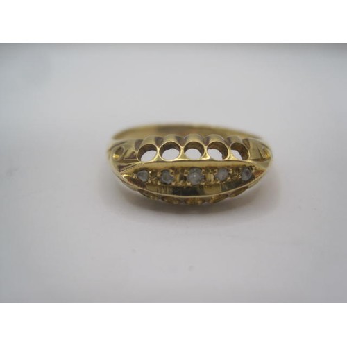 250 - An 18 carat gold ring with a large pierced oval setting, a row of five small graduated diamonds cent... 