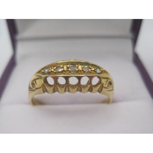 250 - An 18 carat gold ring with a large pierced oval setting, a row of five small graduated diamonds cent... 