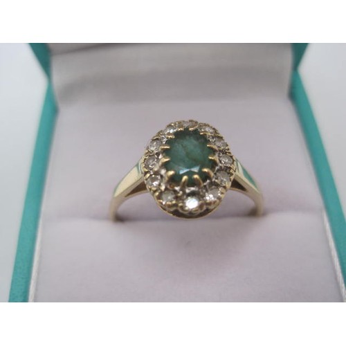 265 - A 9 carat gold emerald and diamond ring. The oval cut emerald (estimated at 5.5mm x 4.5mm) set in a ... 