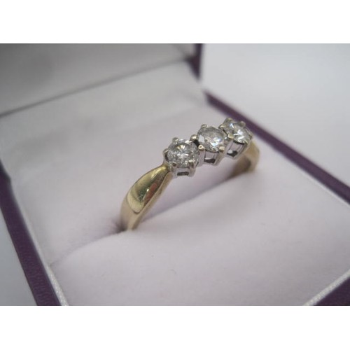 260 - A 9 carat gold ring set with a row of three diamonds in claw settings, ring size Q/R, gross weight o... 