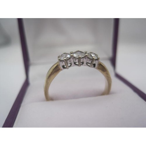 260 - A 9 carat gold ring set with a row of three diamonds in claw settings, ring size Q/R, gross weight o... 