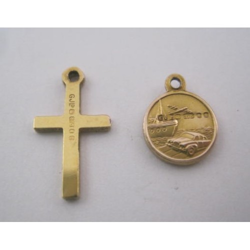 269 - Two 9 carat gold charms - a cross and a St Christopher. The reverse of the St Christopher is decorat... 