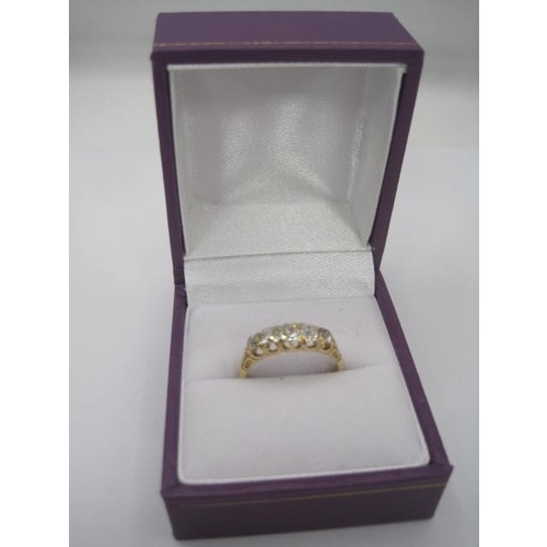 264 - An impressive gold ring set with a row of five graduated diamonds, ring size L, gross weight of ring... 