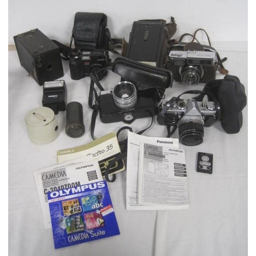 23 - A box of cameras - an a/f spares or repair Olympus OM1 (mechanism feels completely inoperative) with... 