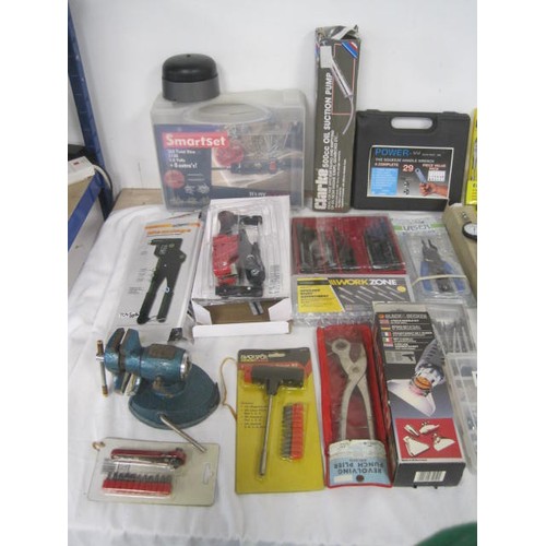 15 - A box of assorted hand tools, including a table vice, several in original packaging