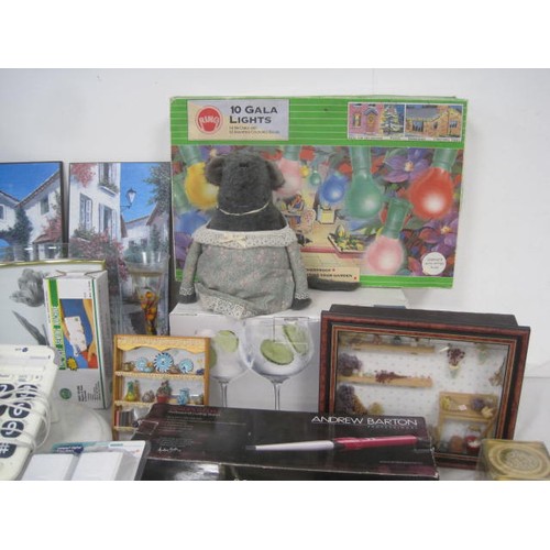 18 - A crate of household and decorative items including a box of large wine glasses, boxed gala lights, ... 