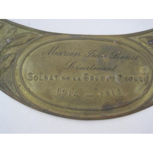 293 - A WW1 French Adrian helmet brass plaque named to Lieutenant Marion Jean Louis. These plaques were pr... 