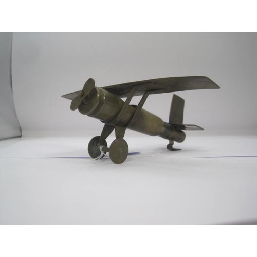 294 - A trench art Monoplane aircraft made from bits of brass with an inert shell case as a fuselage. Wing... 