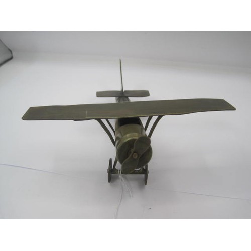 294 - A trench art Monoplane aircraft made from bits of brass with an inert shell case as a fuselage. Wing... 