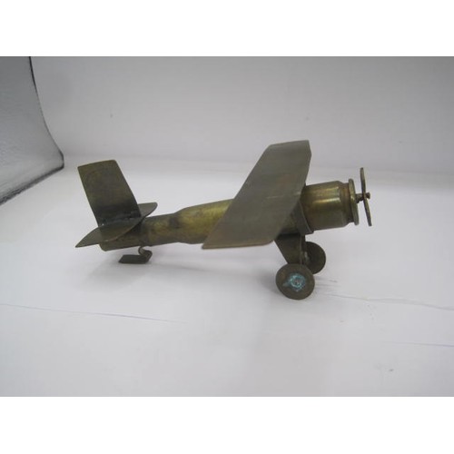 294 - A trench art Monoplane aircraft made from bits of brass with an inert shell case as a fuselage. Wing... 