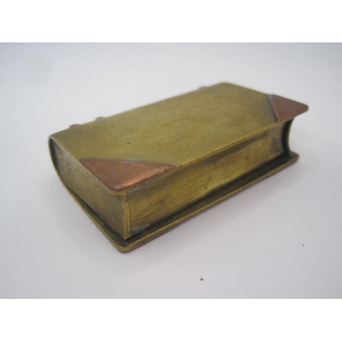 289 - A WW1 trench art lighter in the form of a miniature book. Made of bits of brass and copper. The spin... 