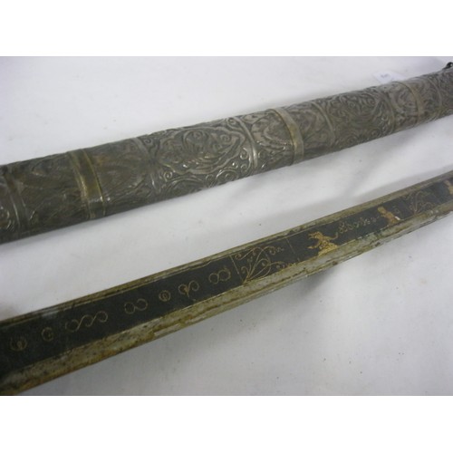 279 - 404 A Burmese Dha with black and gilt decorated blade 52cms long in its profusely decorated white me... 