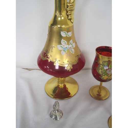 69 - A set of Murano or Venetian hand painted over gold four wine glasses and a handled jug .