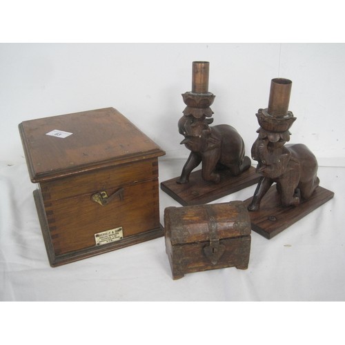 83 - Two carved wooden elephants currently used as candlesticks  along with a wooden box which was design... 