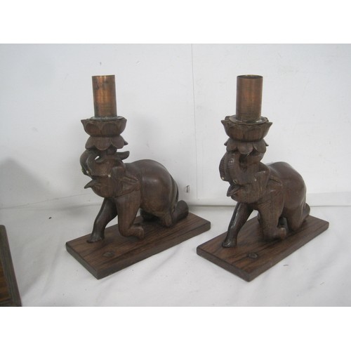 83 - Two carved wooden elephants currently used as candlesticks  along with a wooden box which was design... 