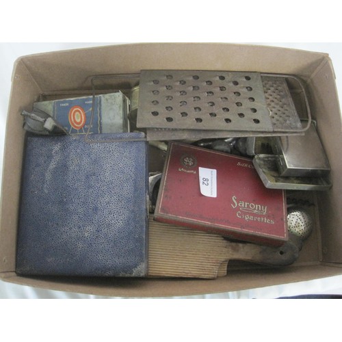 82 - A small cardboard box containing a number of Kitchen related items Knifes, Forks, Cheese grater etc ... 